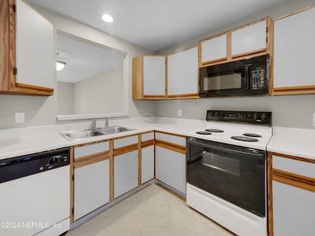 kitchen with dishwasher, sink, white cabinets, and electric stove