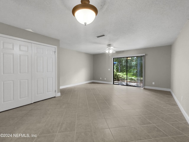 interior space featuring ceiling fan and a textured ceiling