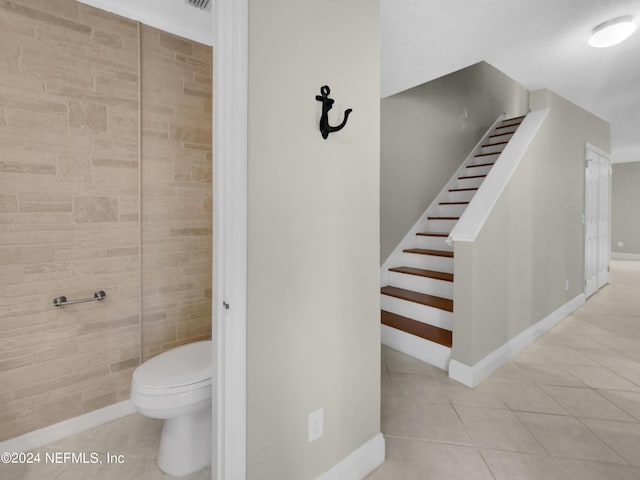 bathroom with tile patterned flooring and toilet