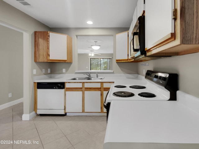 kitchen featuring sink, white cabinetry, light tile patterned floors, dishwasher, and range with electric cooktop