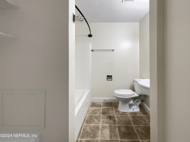 bathroom with tile patterned floors, shower / bathtub combination, and toilet