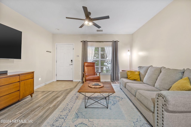 living room with light hardwood / wood-style flooring and ceiling fan