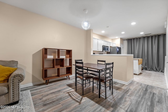 dining space with light wood-type flooring