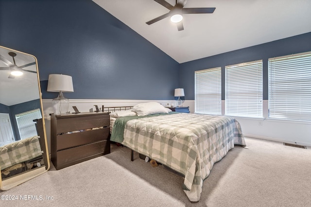 bedroom featuring vaulted ceiling, light colored carpet, and ceiling fan