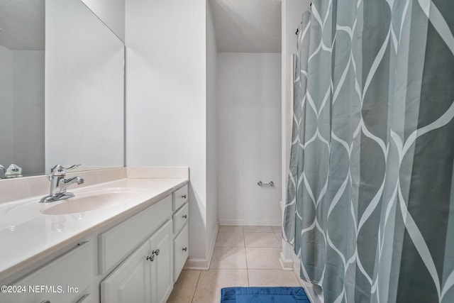 bathroom featuring tile patterned flooring and vanity