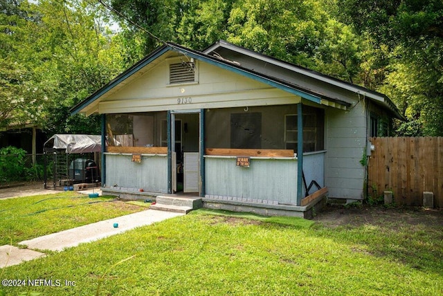 bungalow-style home featuring fence and a front yard