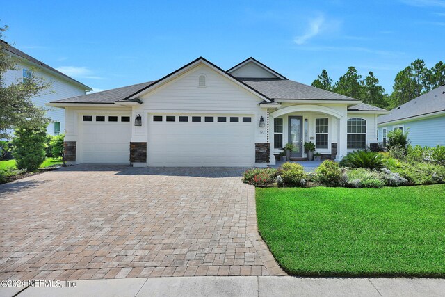 view of front facade with a front lawn and a garage