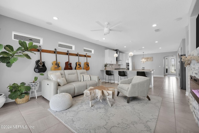 tiled living room with ceiling fan