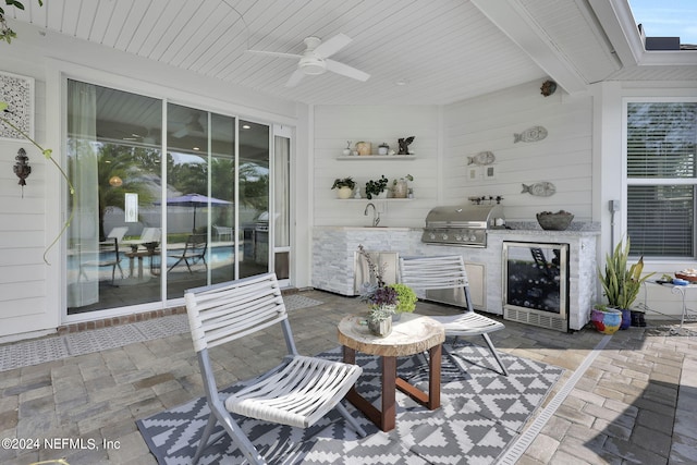 view of patio / terrace featuring a grill, area for grilling, sink, and ceiling fan