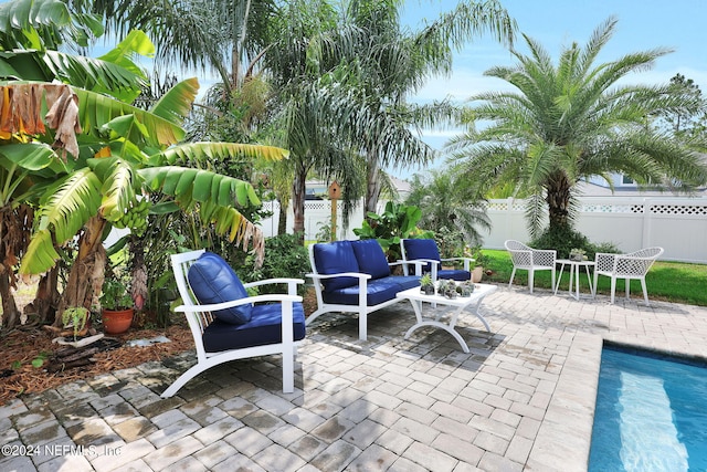 view of patio featuring a fenced in pool and outdoor lounge area