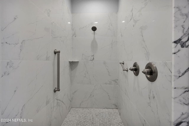 bathroom with a tile shower