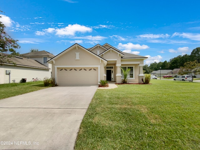 view of front of home featuring a garage and a front lawn