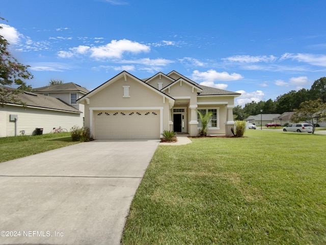 view of front of house with a garage and a front lawn