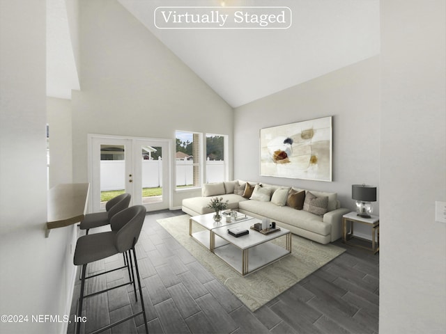 living room with high vaulted ceiling and french doors