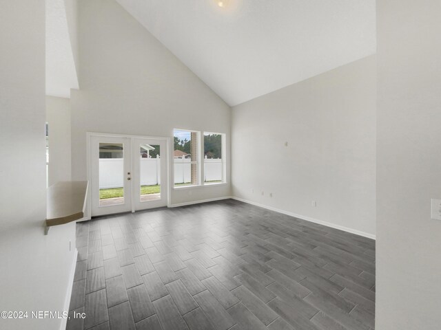 spare room featuring high vaulted ceiling, french doors, and wood-type flooring