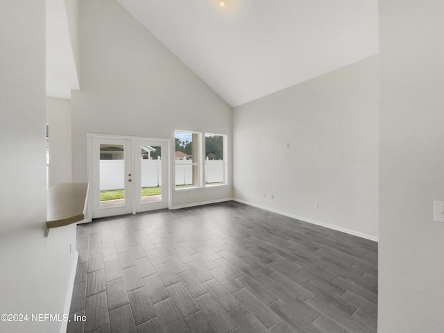 empty room featuring high vaulted ceiling and french doors