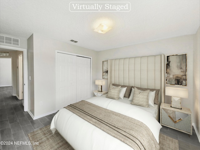 bedroom featuring a closet and a textured ceiling