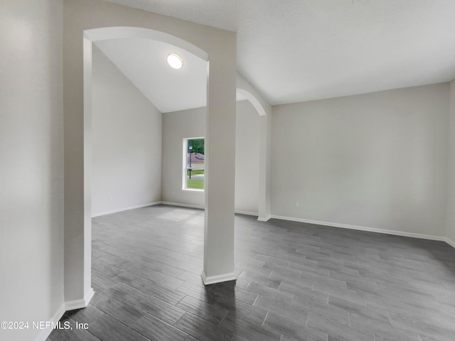 empty room featuring lofted ceiling and hardwood / wood-style floors