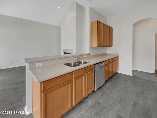 kitchen with stainless steel dishwasher, sink, kitchen peninsula, and light hardwood / wood-style floors