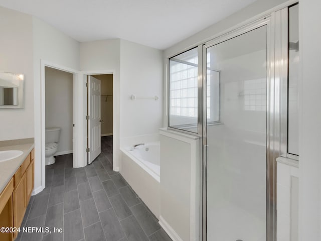 full bathroom with independent shower and bath, vanity, tile patterned floors, and toilet