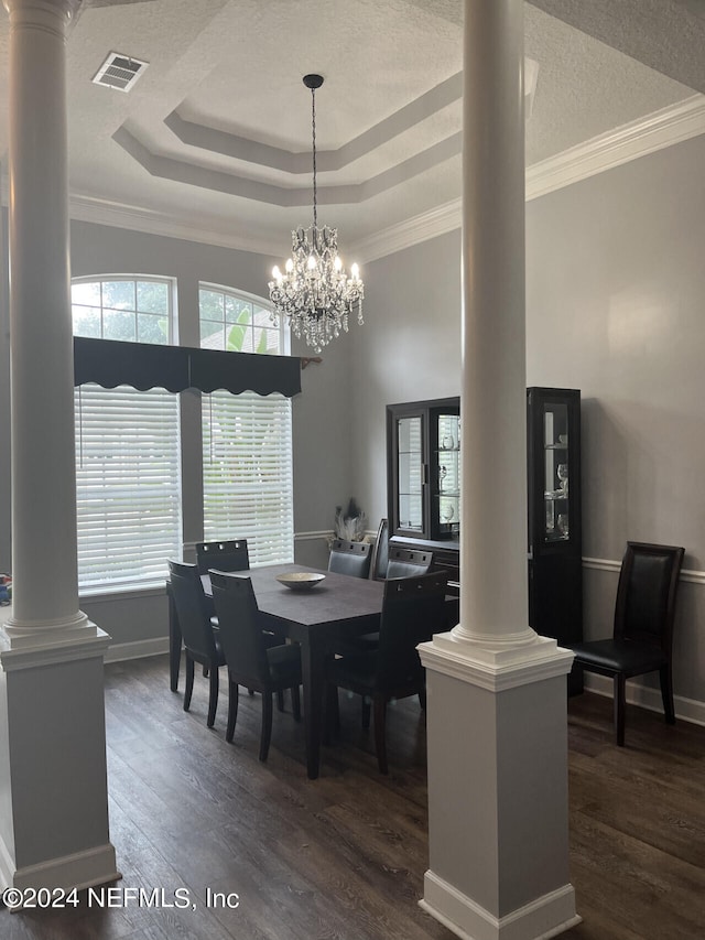 dining room with dark wood-type flooring and ornate columns