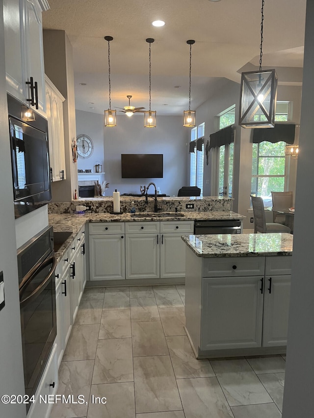 kitchen with black appliances, light tile patterned floors, kitchen peninsula, and sink