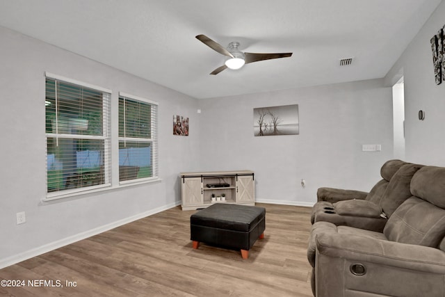 living room with hardwood / wood-style floors and ceiling fan