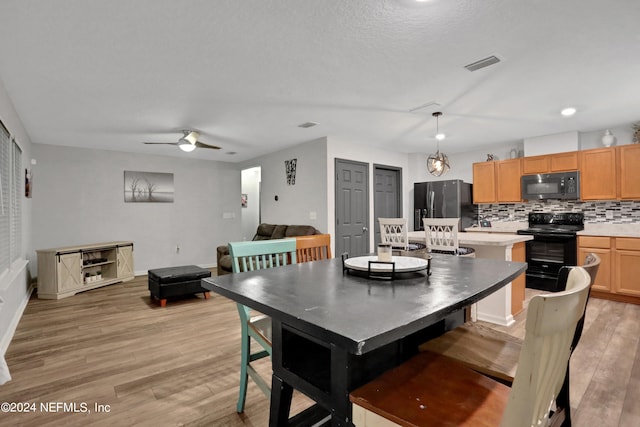 dining space featuring light hardwood / wood-style flooring and ceiling fan