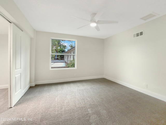 unfurnished bedroom featuring light colored carpet and ceiling fan