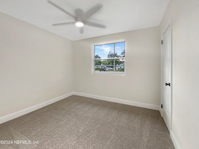 spare room featuring carpet and ceiling fan