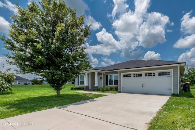 view of front of home featuring a garage and a front yard