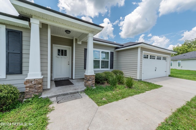 doorway to property with a garage