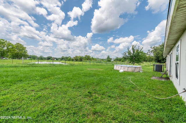 view of yard with a water view and a rural view