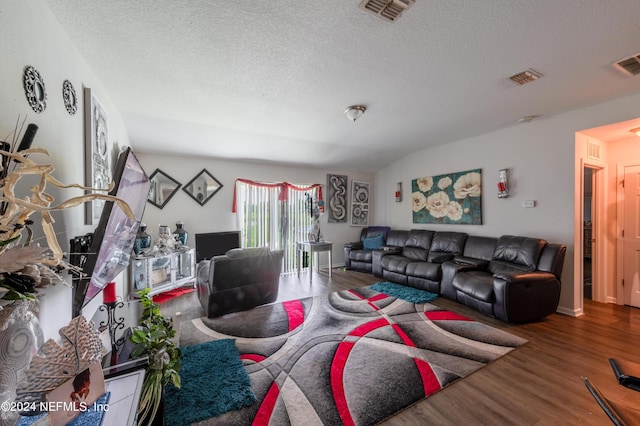 living room featuring hardwood / wood-style flooring and a textured ceiling