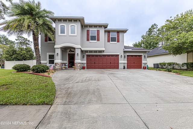 view of front of home with a garage and a front lawn