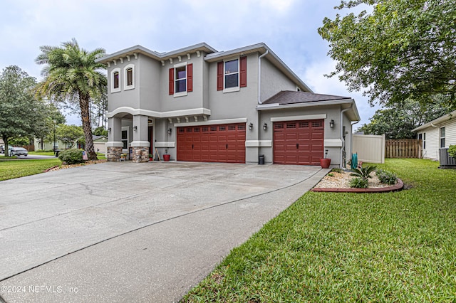 view of front of property with a front yard and a garage