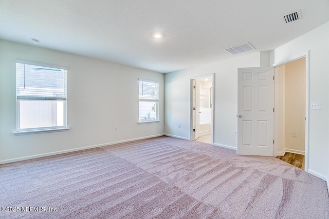 unfurnished room with light carpet