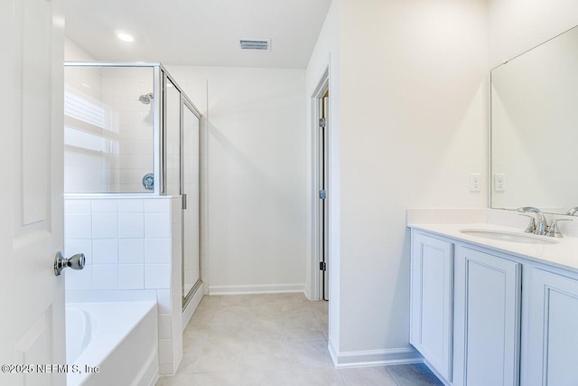 bathroom featuring plus walk in shower, tile patterned flooring, and vanity