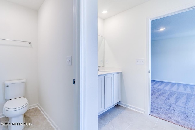 bathroom featuring toilet, vanity, and tile patterned floors