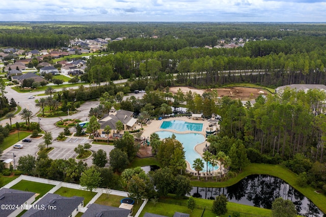 drone / aerial view featuring a water view and a view of trees