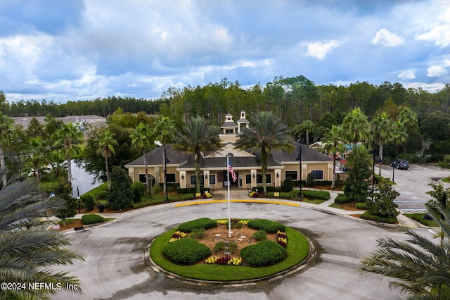 view of building exterior with curved driveway