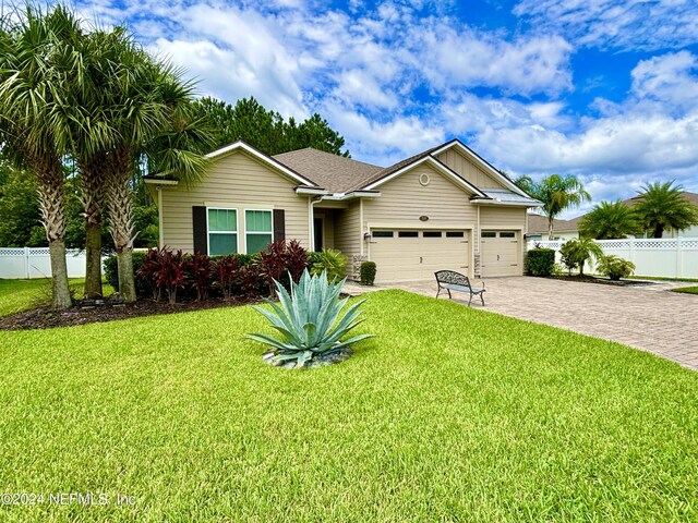 view of front of house featuring a garage and a front lawn