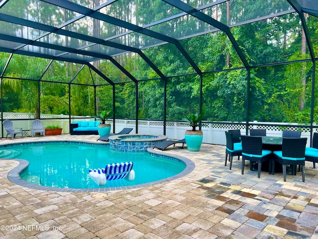 view of swimming pool with glass enclosure and a patio