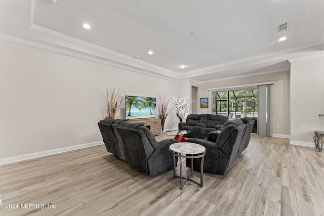 living room featuring visible vents, crown molding, light wood-style flooring, and baseboards