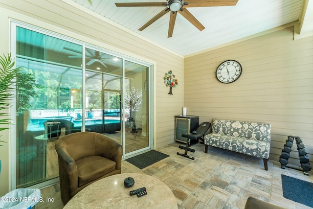 sunroom / solarium featuring ceiling fan