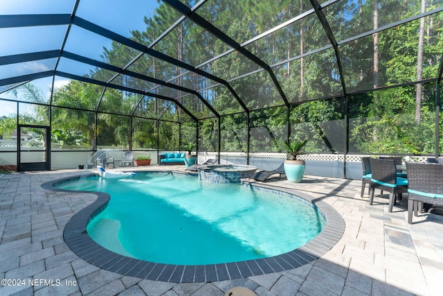 view of pool featuring a lanai, a patio area, and an in ground hot tub