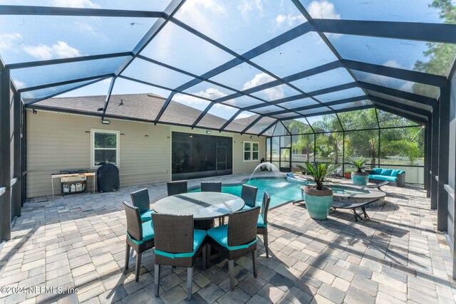 view of patio / terrace with pool water feature and a lanai