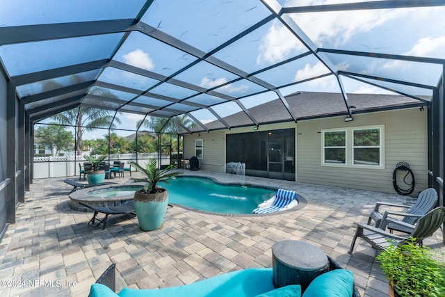 view of pool with a patio and glass enclosure