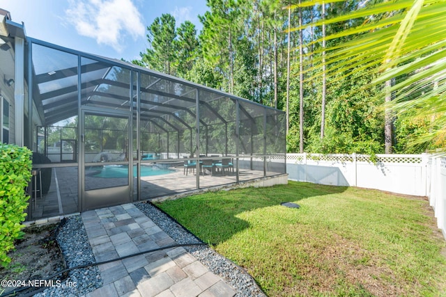 view of yard with a patio, glass enclosure, a fenced backyard, and a fenced in pool