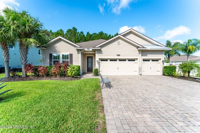 ranch-style home with a front lawn and a garage